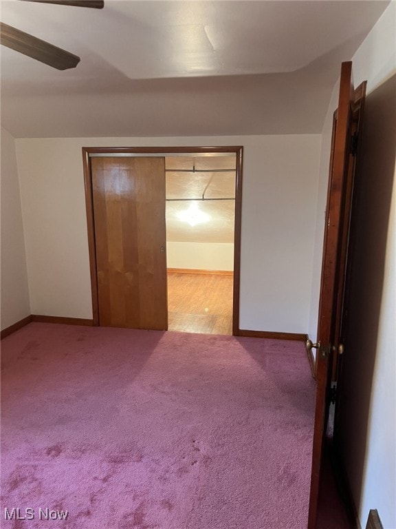 unfurnished bedroom featuring ceiling fan and carpet floors