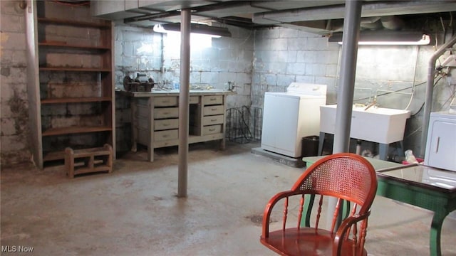 basement with washing machine and dryer and sink