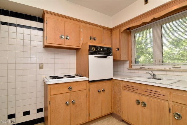 kitchen featuring tasteful backsplash, sink, and white appliances