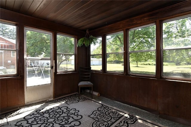 unfurnished sunroom featuring plenty of natural light and wood ceiling