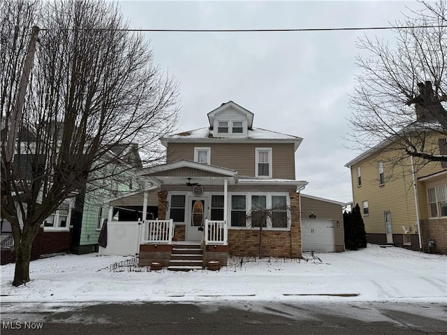 view of front property featuring a porch and a garage