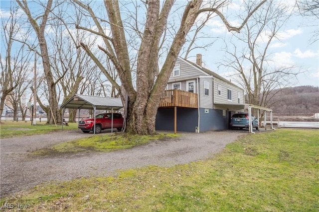 view of front of house featuring a deck and a front lawn