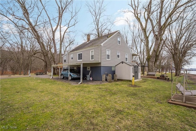 view of home's exterior with a yard and a carport