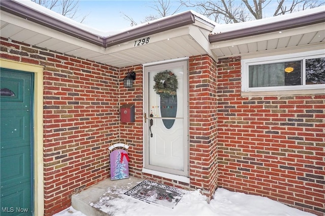 view of snow covered property entrance