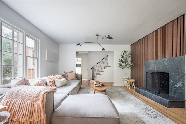 living room featuring hardwood / wood-style flooring and a premium fireplace