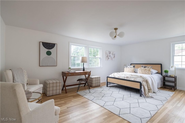 bedroom with light wood-type flooring and multiple windows