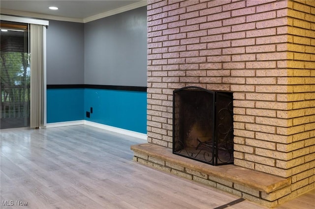 unfurnished living room with crown molding, wood-type flooring, and a fireplace