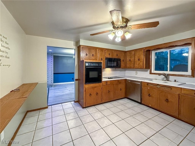 kitchen featuring light tile patterned flooring, sink, ceiling fan, and black appliances