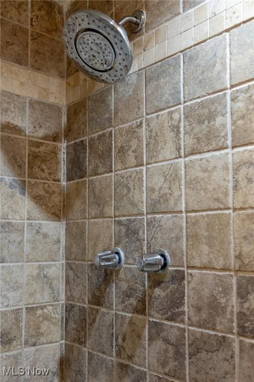 bathroom with a tile shower