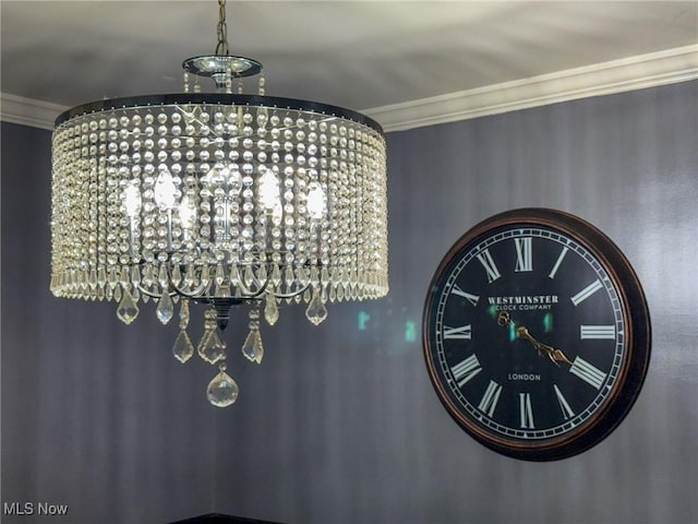 interior details with crown molding and a chandelier