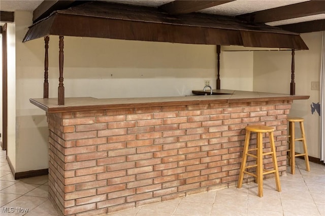 bar featuring light tile patterned floors