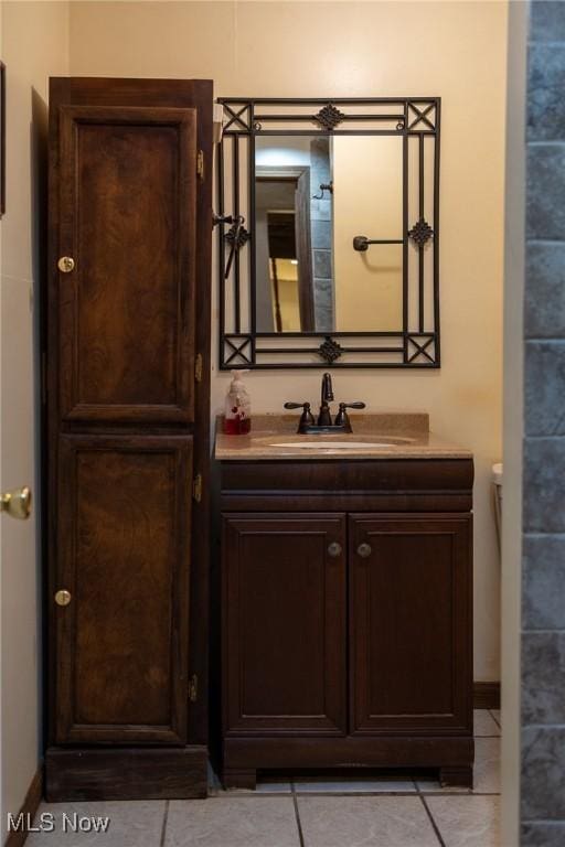 bathroom featuring tile patterned flooring and vanity