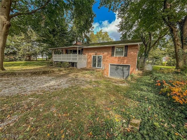 rear view of house with a garage