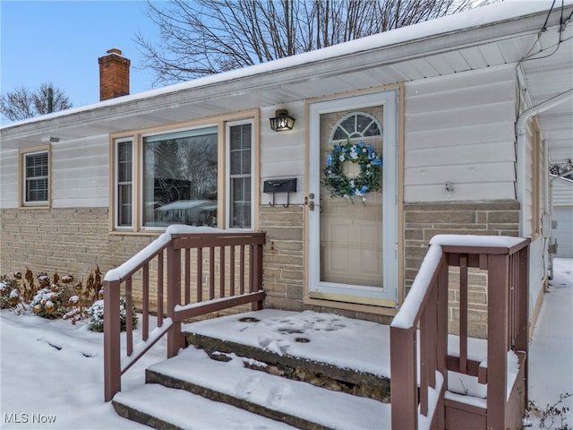 view of snow covered property entrance