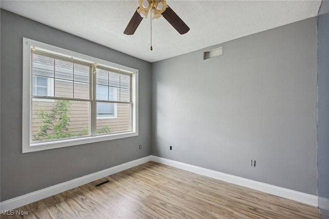 empty room with light wood-type flooring and ceiling fan