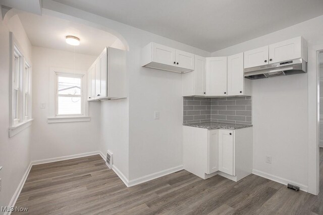 laundry area with dark wood-type flooring