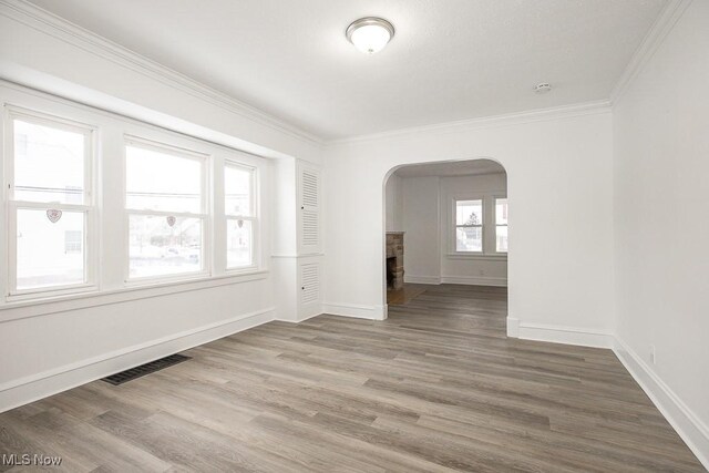 unfurnished room with hardwood / wood-style flooring and ornamental molding