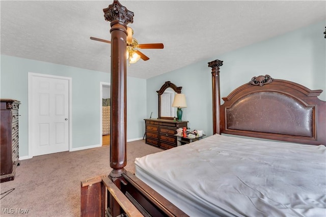 bedroom featuring a textured ceiling, light colored carpet, and ceiling fan