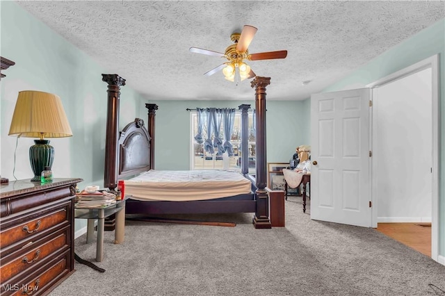 bedroom featuring ceiling fan, light colored carpet, and a textured ceiling