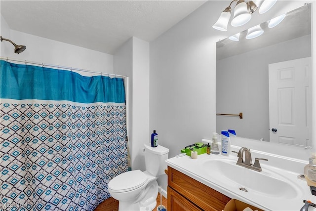 bathroom featuring a shower with curtain, vanity, and toilet