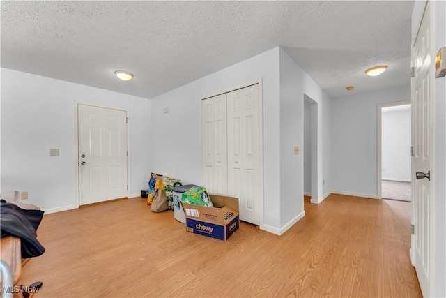 entrance foyer featuring light hardwood / wood-style floors and a textured ceiling