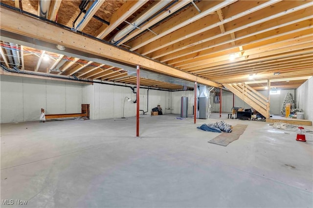 basement featuring heating unit and water heater