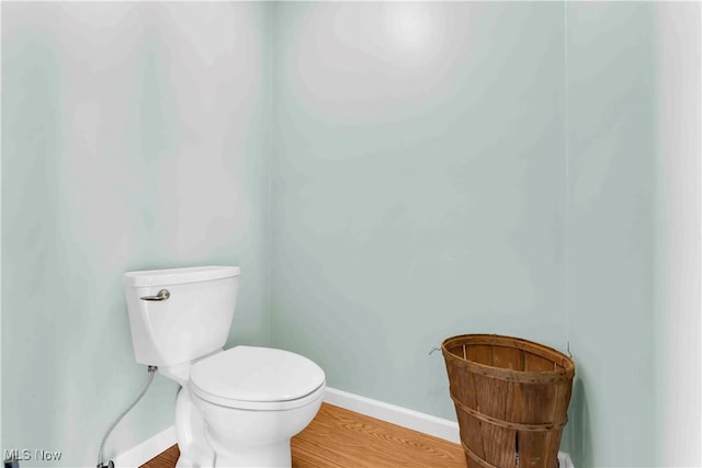 bathroom with toilet and wood-type flooring