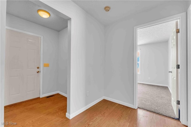 entryway featuring hardwood / wood-style floors and a textured ceiling