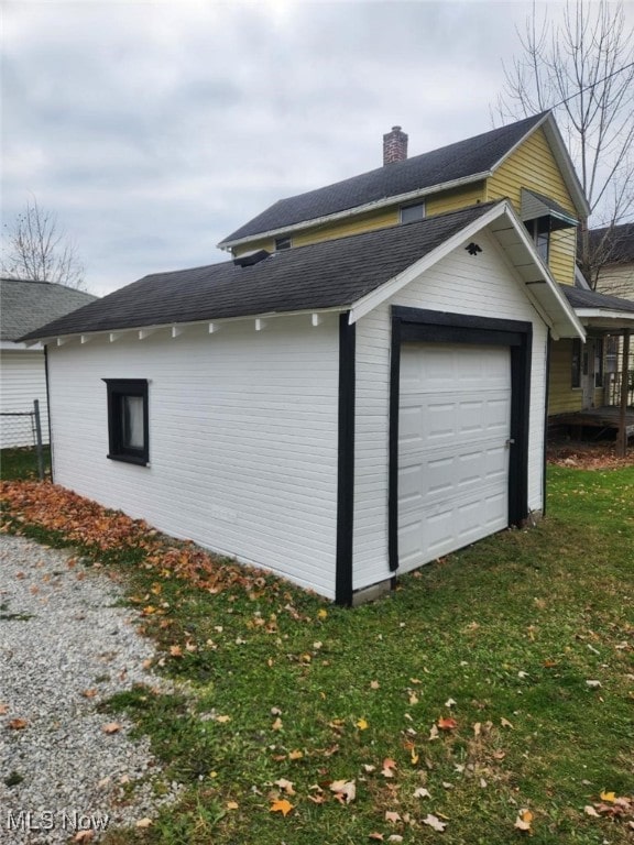 view of home's exterior featuring a lawn and a garage