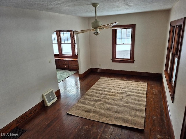 empty room featuring ceiling fan and dark hardwood / wood-style flooring