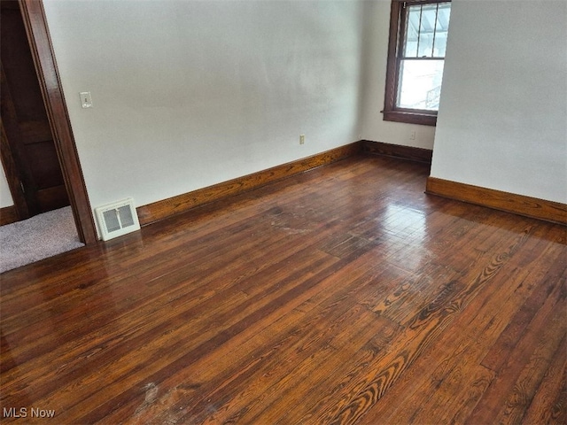 unfurnished room with dark hardwood / wood-style floors