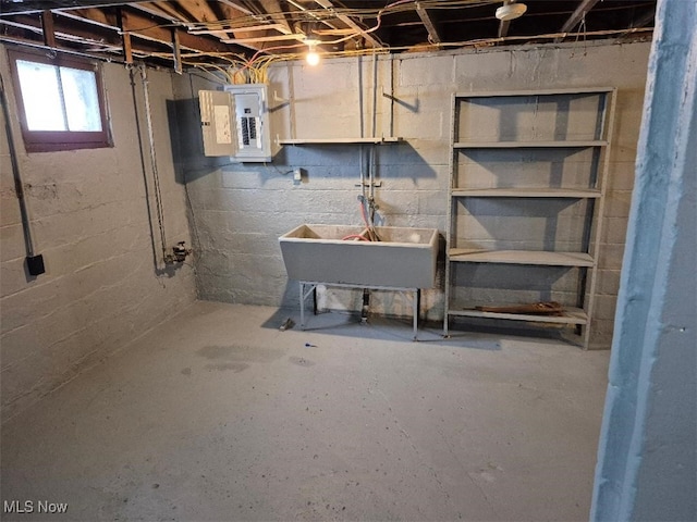 basement featuring electric panel and sink