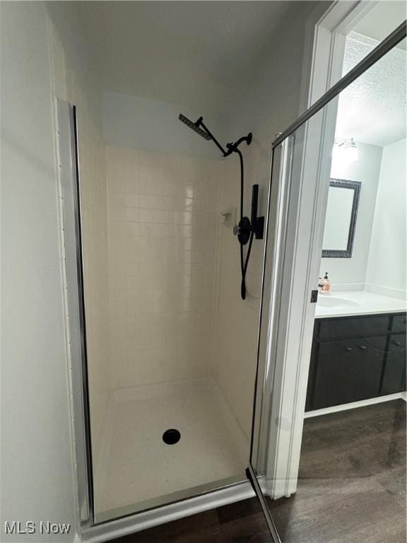 bathroom featuring vanity and tiled shower