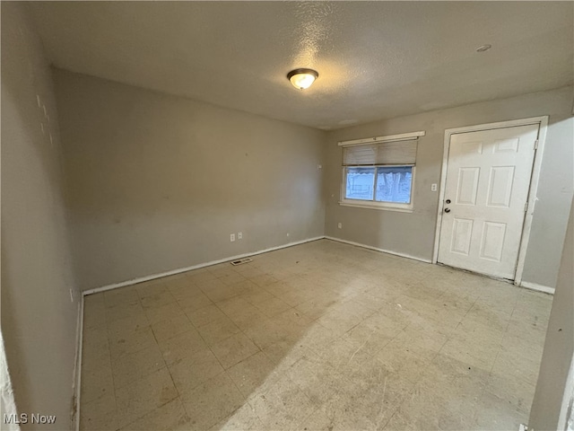 empty room featuring a textured ceiling