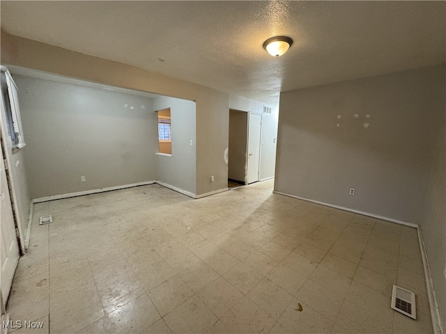 spare room featuring a textured ceiling