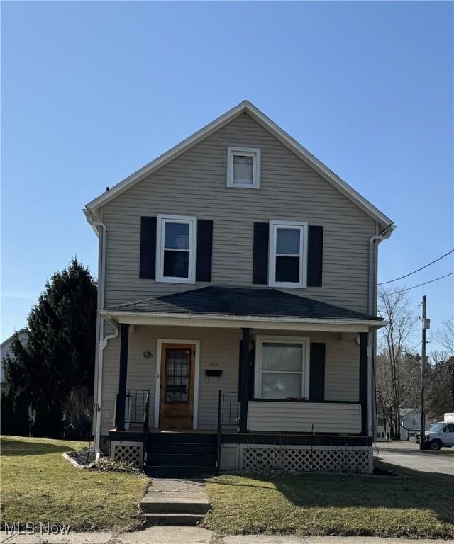 view of front facade with covered porch and a front yard