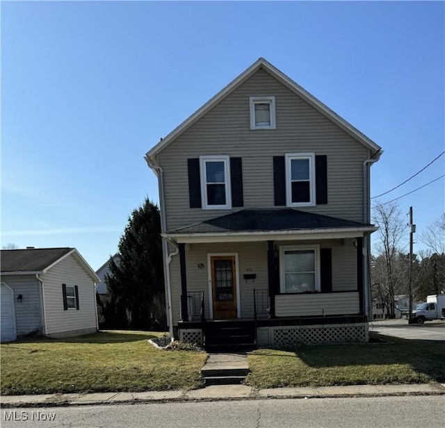 view of front of property featuring a front lawn and covered porch