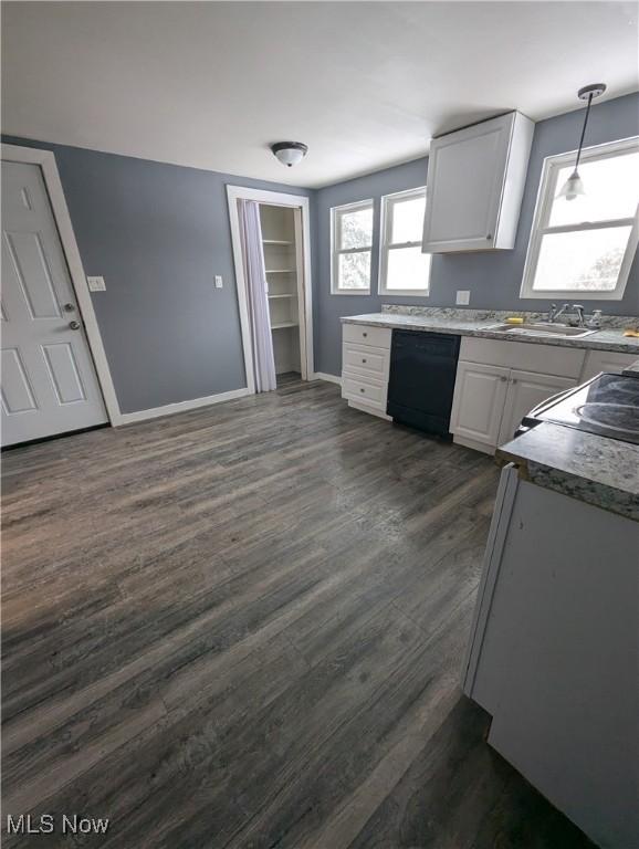 kitchen featuring white cabinets, dark wood-type flooring, sink, decorative light fixtures, and dishwasher