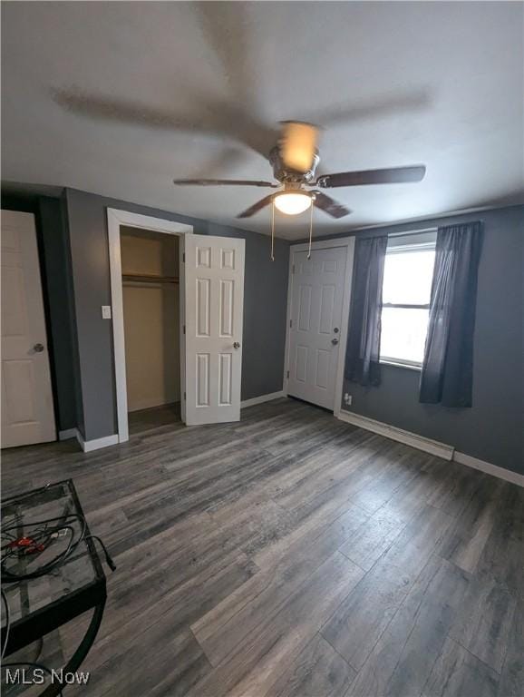 unfurnished bedroom featuring dark hardwood / wood-style flooring and ceiling fan