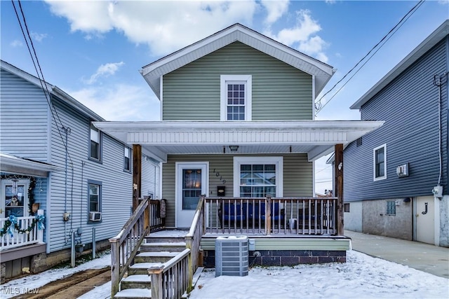 view of front of property with a porch and central AC