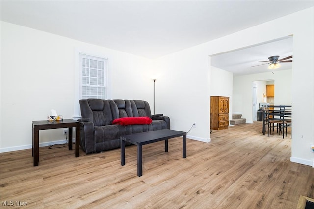 living area with ceiling fan and light wood-type flooring