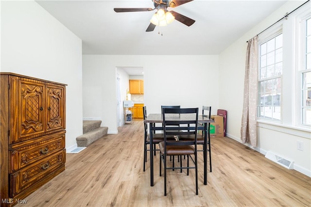 dining area featuring light wood-type flooring and ceiling fan