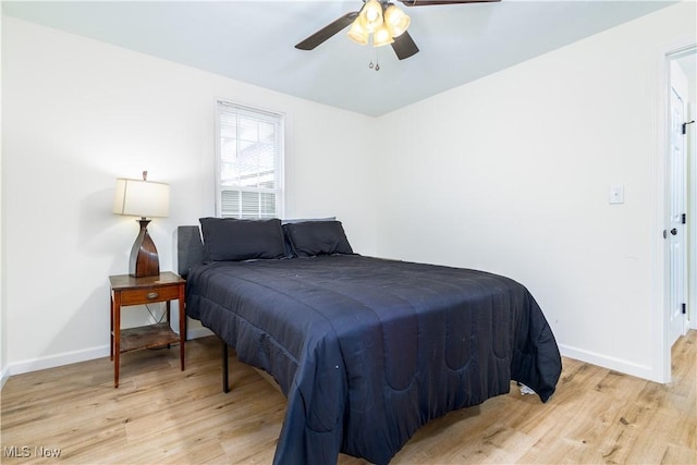 bedroom with light hardwood / wood-style floors and ceiling fan