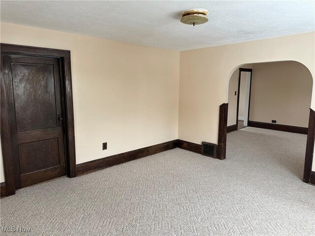 spare room with a textured ceiling