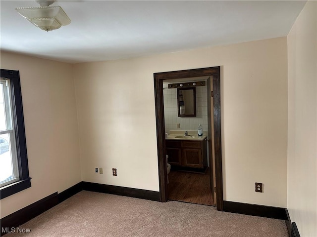 carpeted empty room with sink