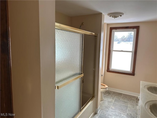 full bathroom with vanity, toilet, and shower / bath combination with glass door