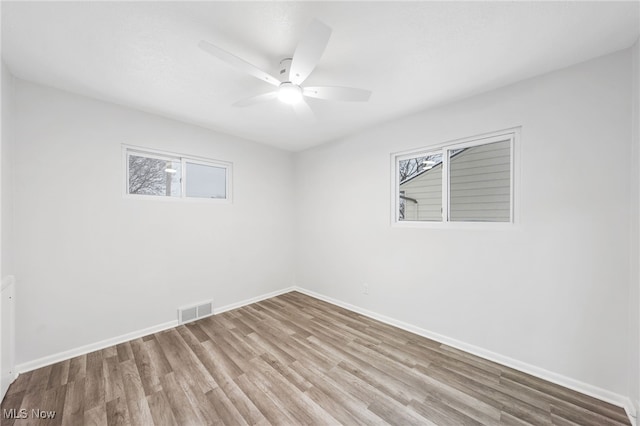 unfurnished room with ceiling fan and light wood-type flooring