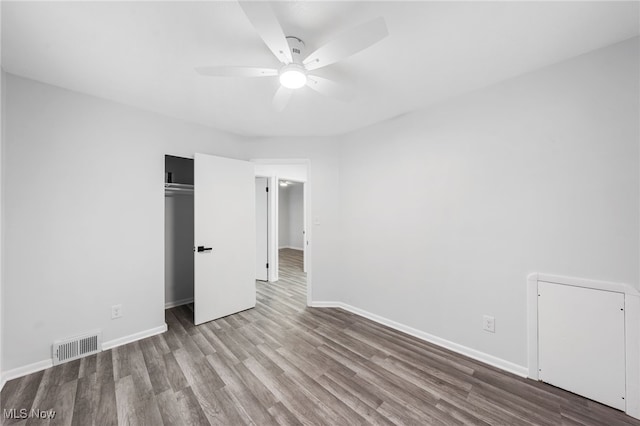 unfurnished bedroom with ceiling fan, a closet, and light hardwood / wood-style flooring