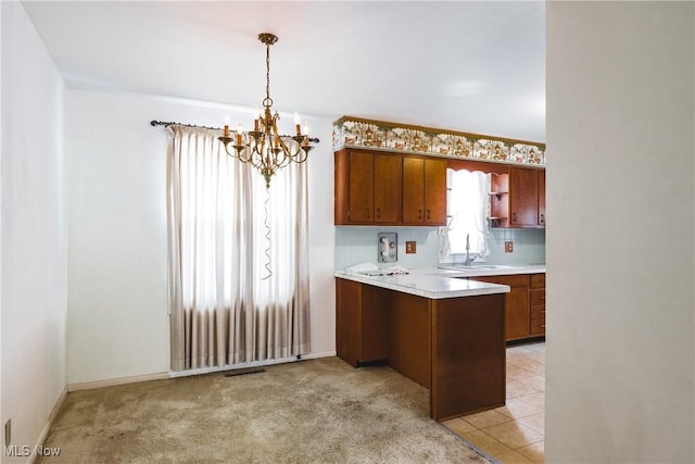 kitchen with sink, backsplash, a chandelier, light colored carpet, and pendant lighting