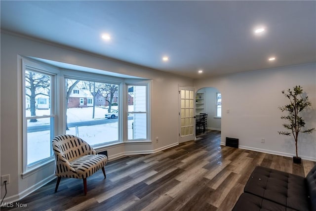 sitting room with dark hardwood / wood-style floors and ornamental molding